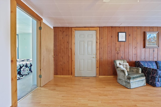 8075 Caine Rd, Millington, MI 48746 - sitting room with light wood-style floors and wood walls