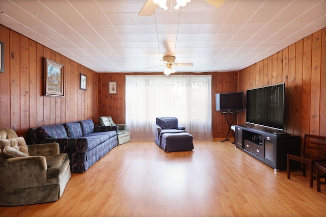 8075 Caine Rd, Millington, MI 48746 - living area featuring ceiling fan, light wood finished floors, and wood walls