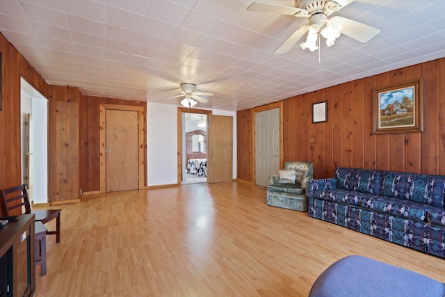 8075 Caine Rd, Millington, MI 48746 - living area featuring a ceiling fan, wooden walls, and wood finished floors