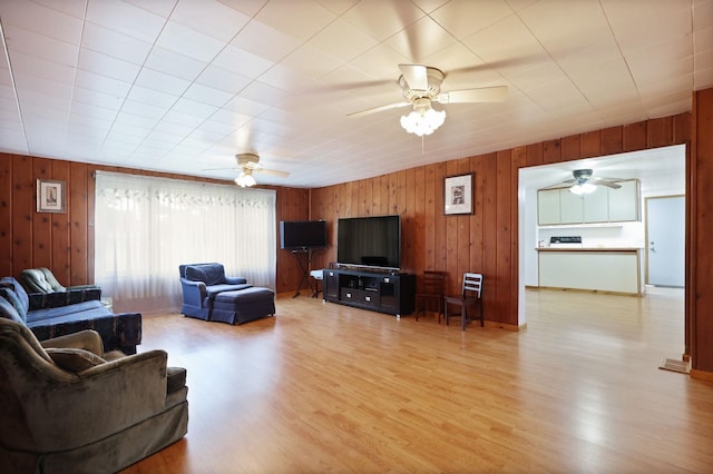 8075 Caine Rd, Millington, MI 48746 - living room featuring a ceiling fan, wooden walls, and wood finished floors