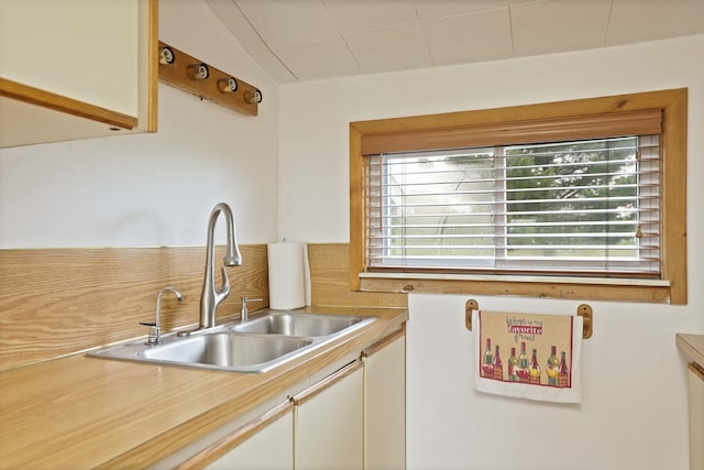 8075 Caine Rd, Millington, MI 48746 - kitchen featuring light countertops, white cabinetry, and lofted ceiling
