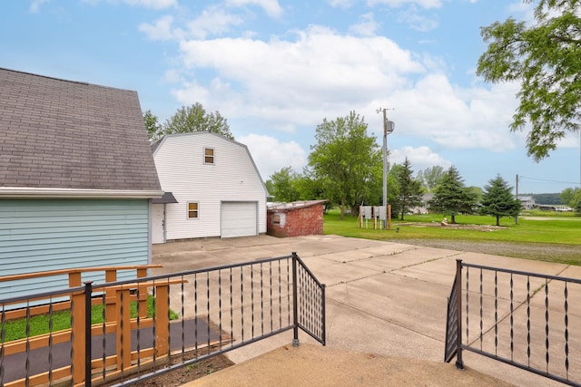 8075 Caine Rd, Millington, MI 48746 - view of patio / terrace featuring driveway and an outbuilding