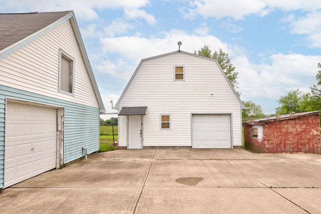 8075 Caine Rd, Millington, MI 48746 - view of property exterior featuring an outdoor structure and a detached garage