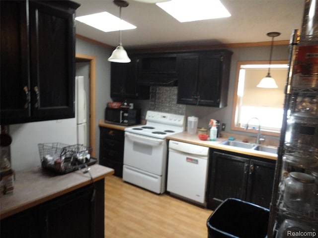 29269 Hidden River Dr, Gibraltar, MI 48173 - kitchen featuring white appliances, dark cabinetry, and hanging light fixtures