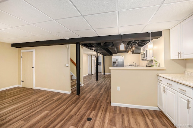 964 W Marshall St, Ferndale, MI 48220 - finished below grade area featuring stainless steel fridge with ice dispenser, a drop ceiling, dark wood-style floors, and stairway
