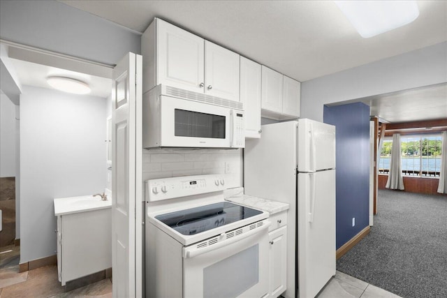 12915 S Englewright Dr, Sand Lake, MI 49343 - kitchen featuring white appliances, white cabinetry, and light countertops
