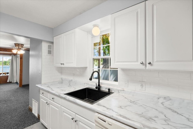 12915 S Englewright Dr, Sand Lake, MI 49343 - kitchen featuring white cabinets, decorative backsplash, ceiling fan, and carpet flooring