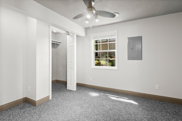 12915 S Englewright Dr, Sand Lake, MI 49343 - unfurnished bedroom featuring electric panel, carpet flooring, a textured ceiling, and ceiling fan