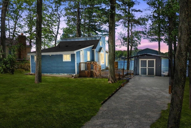 12915 S Englewright Dr, Sand Lake, MI 49343 - view of front of home featuring a storage shed and a front yard