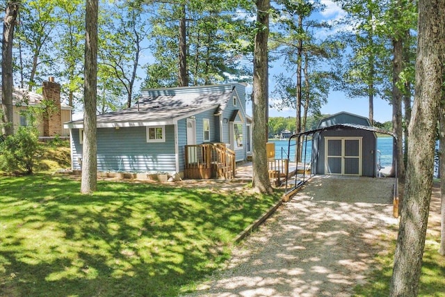 12915 S Englewright Dr, Sand Lake, MI 49343 - view of front facade with a storage shed and a front yard