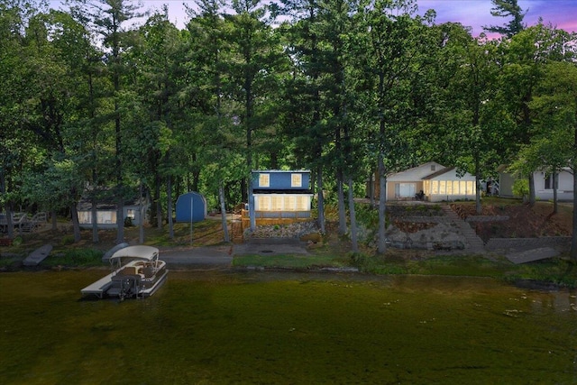 12915 S Englewright Dr, Sand Lake, MI 49343 - view of front of house with a shed and a boat dock