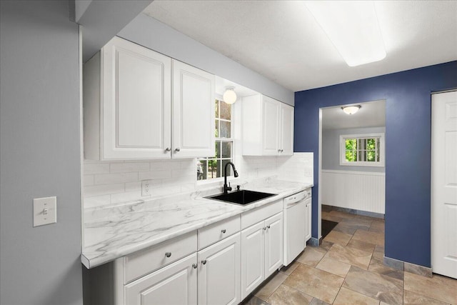 12915 S Englewright Dr, Sand Lake, MI 49343 - kitchen featuring dishwasher, light stone finish floors, tasteful backsplash, and white cabinets