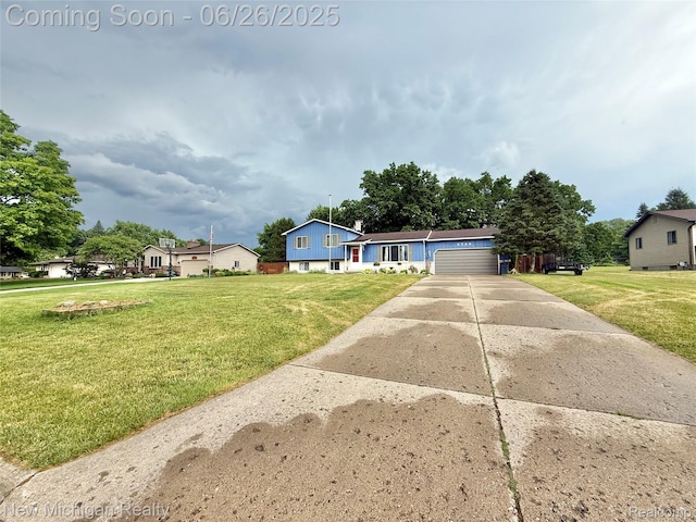 8588 Tim Tam Trl, Flushing, MI 48433 - tri-level home featuring a front lawn, concrete driveway, and an attached garage