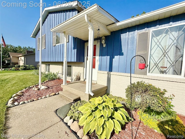 8588 Tim Tam Trl, Flushing, MI 48433 - doorway to property with board and batten siding and a yard