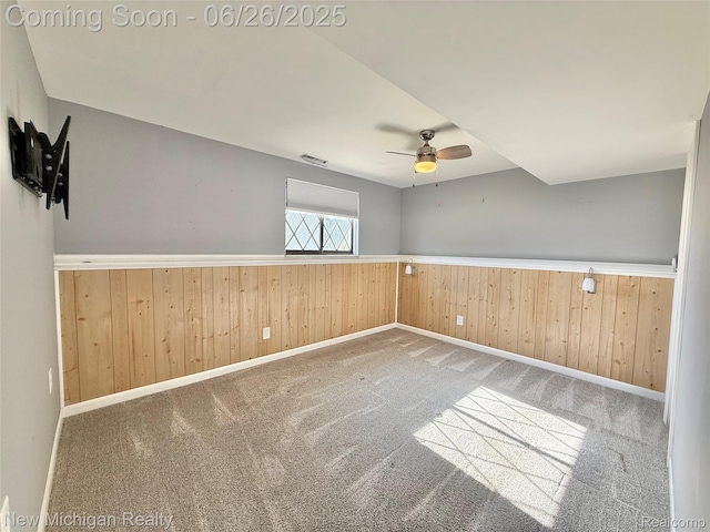 8588 Tim Tam Trl, Flushing, MI 48433 - carpeted spare room featuring wainscoting, a ceiling fan, and wood walls