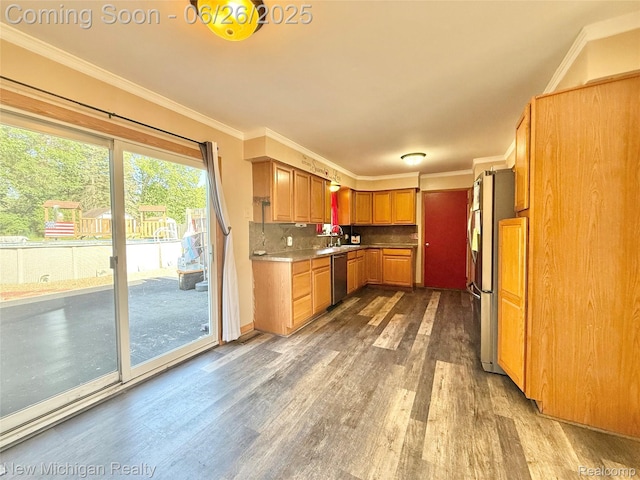 8588 Tim Tam Trl, Flushing, MI 48433 - kitchen with wood finished floors, crown molding, appliances with stainless steel finishes, decorative backsplash, and light countertops
