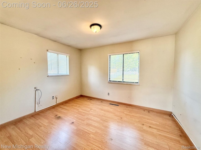 8588 Tim Tam Trl, Flushing, MI 48433 - spare room featuring plenty of natural light and wood finished floors