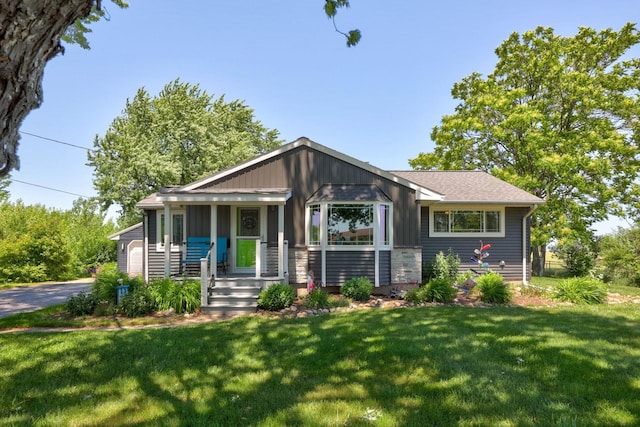5255 E Holland Rd, Saginaw, MI 48601 - view of front of property with a front lawn and covered porch