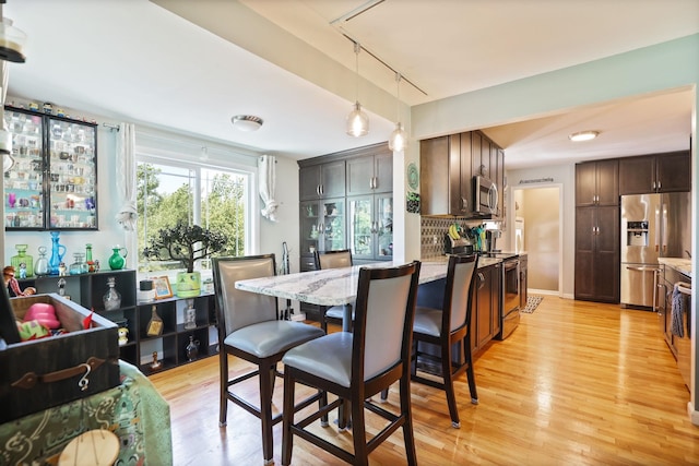 5255 E Holland Rd, Saginaw, MI 48601 - dining room featuring rail lighting and light wood-style floors