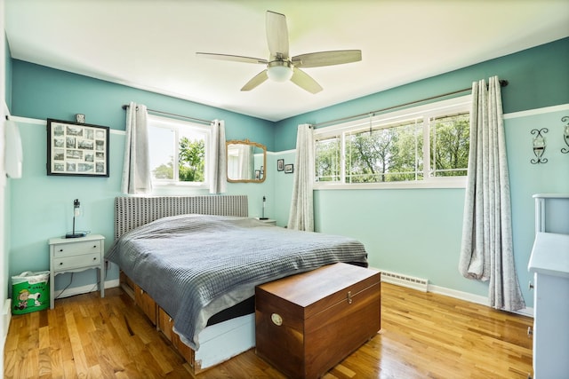 5255 E Holland Rd, Saginaw, MI 48601 - bedroom with multiple windows, wood finished floors, and ceiling fan