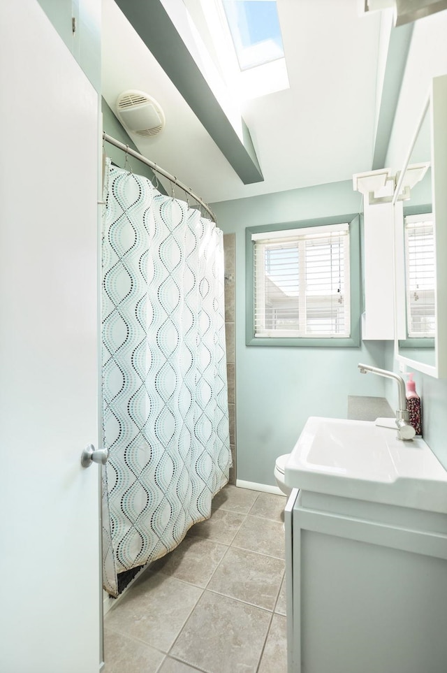 5255 E Holland Rd, Saginaw, MI 48601 - full bath with vanity, healthy amount of natural light, tile patterned flooring, and a skylight