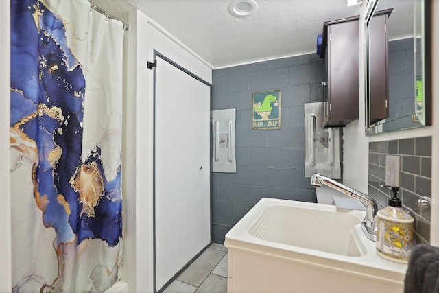 5255 E Holland Rd, Saginaw, MI 48601 - full bath with concrete block wall, a shower with curtain, and tile patterned floors