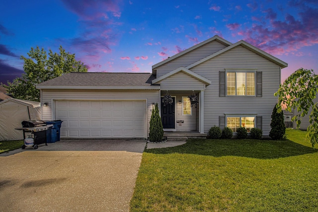613 Silver Birch St, Howard City, MI 49329 - tri-level home featuring driveway, an attached garage, and a front yard