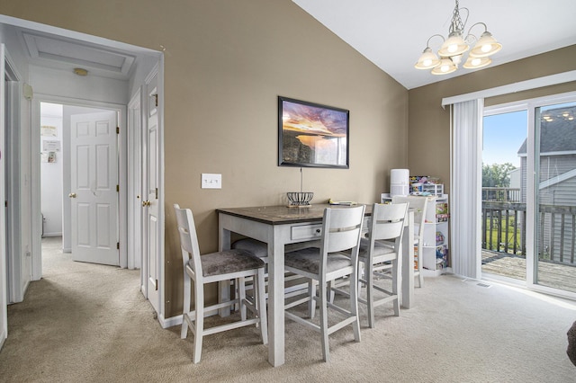 613 Silver Birch St, Howard City, MI 49329 - dining space featuring light carpet, vaulted ceiling, and a chandelier
