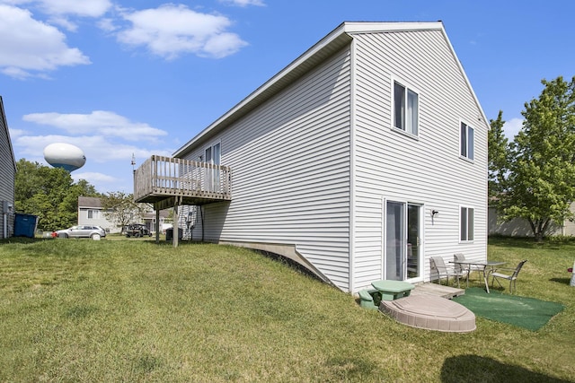 613 Silver Birch St, Howard City, MI 49329 - rear view of property featuring a lawn and a deck