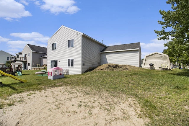 613 Silver Birch St, Howard City, MI 49329 - back of property with a playground and a lawn