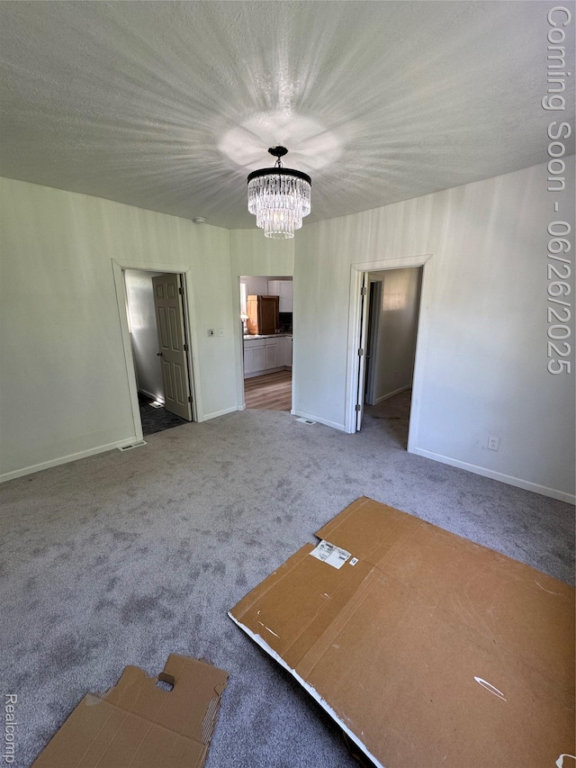 2063 Meade St, Hamtramck, MI 48212 - unfurnished living room featuring a chandelier and carpet flooring