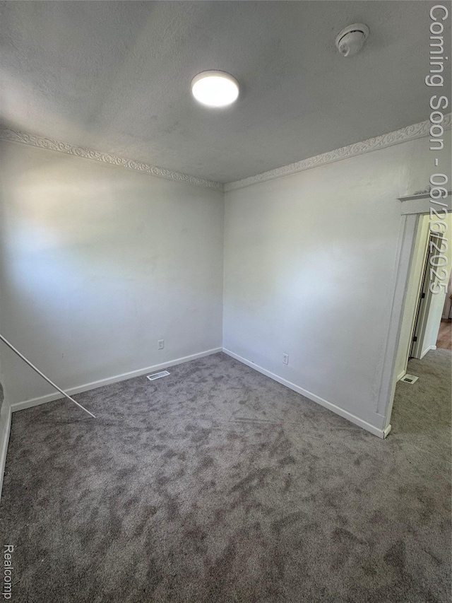 2063 Meade St, Hamtramck, MI 48212 - empty room featuring carpet floors, a smoke detector, and a textured ceiling