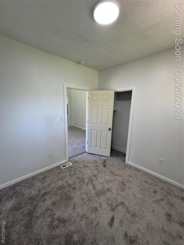 2063 Meade St, Hamtramck, MI 48212 - unfurnished bedroom with carpet floors and a textured ceiling
