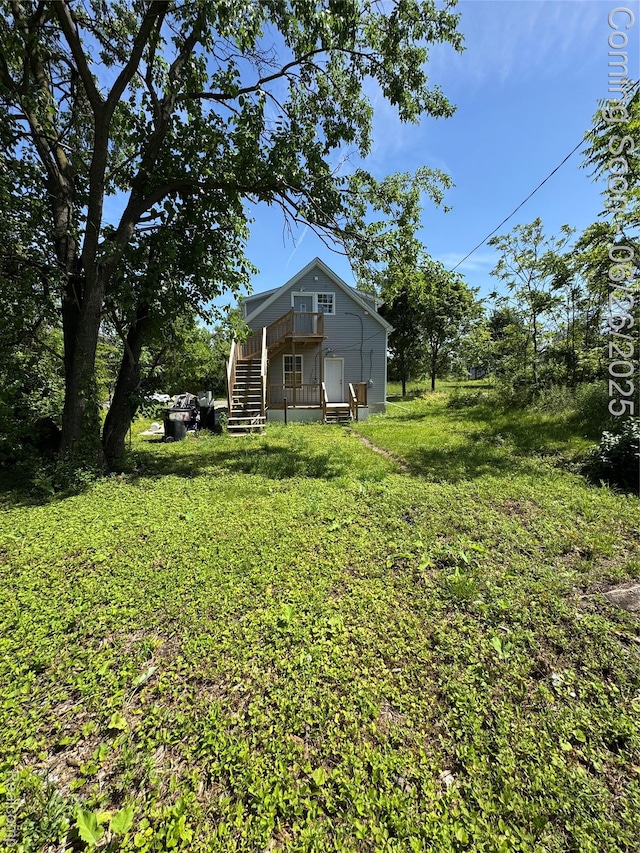 2063 Meade St, Hamtramck, MI 48212 - view of grassy yard with stairway and a wooden deck