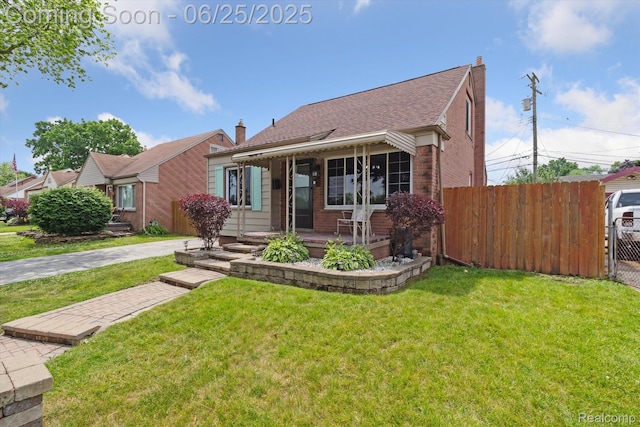 647 Farnham Ave, Lincoln Park, MI 48146 - view of front of home with brick siding, a porch, a chimney, and roof with shingles