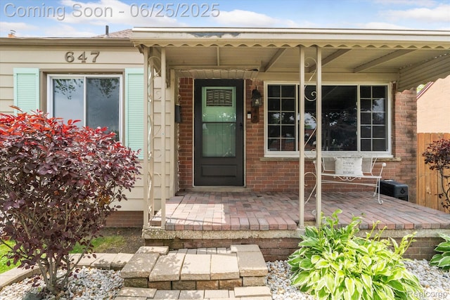 647 Farnham Ave, Lincoln Park, MI 48146 - view of exterior entry with a porch and brick siding