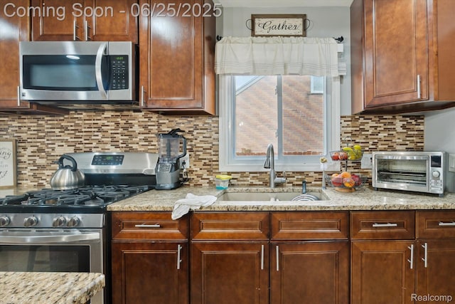 647 Farnham Ave, Lincoln Park, MI 48146 - kitchen featuring stainless steel appliances, decorative backsplash, and light stone counters
