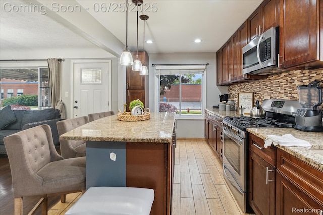 647 Farnham Ave, Lincoln Park, MI 48146 - kitchen with appliances with stainless steel finishes, light wood finished floors, backsplash, light stone countertops, and recessed lighting