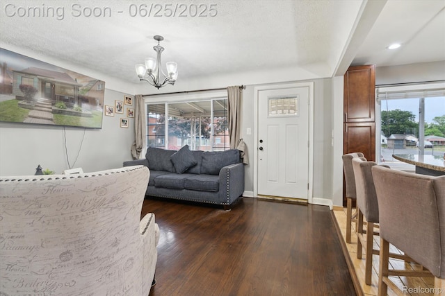647 Farnham Ave, Lincoln Park, MI 48146 - living area featuring a chandelier, dark wood-style floors, healthy amount of natural light, and a textured ceiling
