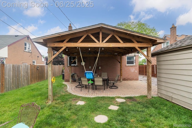 647 Farnham Ave, Lincoln Park, MI 48146 - back of property featuring brick siding, a fenced backyard, a gazebo, and a patio area