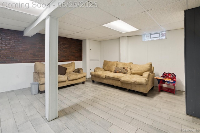 647 Farnham Ave, Lincoln Park, MI 48146 - living room with a drop ceiling, wood finished floors, and brick wall