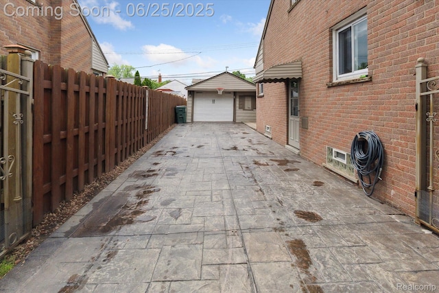 647 Farnham Ave, Lincoln Park, MI 48146 - view of patio with concrete driveway, an outbuilding, and a garage