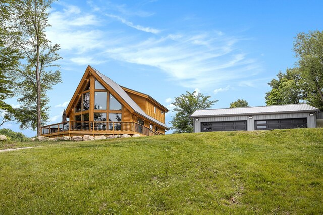 12349 N Sherman Lake Dr, Augusta, MI 49012 - rear view of house with a garage, a yard, a deck, and an outbuilding