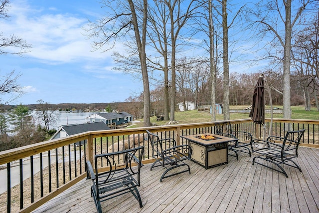12349 N Sherman Lake Dr, Augusta, MI 49012 - wooden terrace featuring an outdoor fire pit and a water view