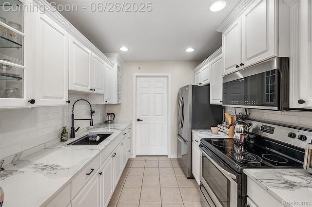 21958 Hartford Way, Macomb, MI 48042 - kitchen with appliances with stainless steel finishes, white cabinets, decorative backsplash, glass insert cabinets, and recessed lighting