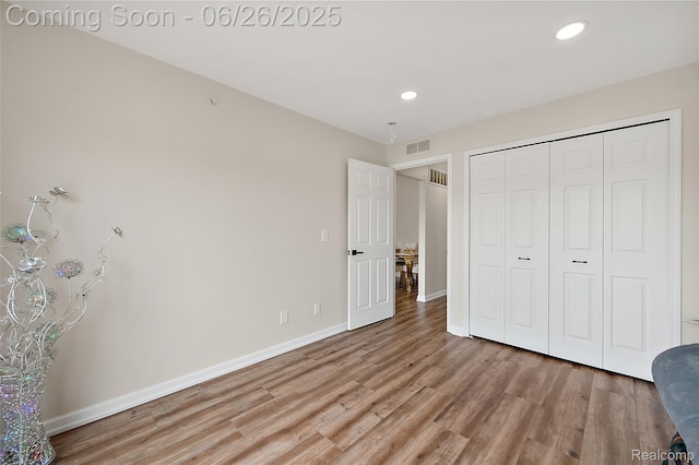 21958 Hartford Way, Macomb, MI 48042 - unfurnished bedroom featuring light wood finished floors, recessed lighting, and a closet