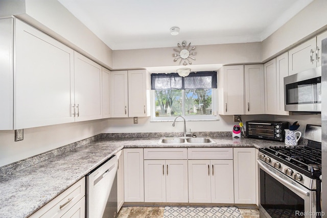 2126 Covert Rd, Burton, MI 48509 - kitchen featuring appliances with stainless steel finishes and white cabinetry