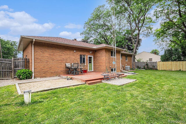 2126 Covert Rd, Burton, MI 48509 - back of house with a fenced backyard, brick siding, and a wooden deck