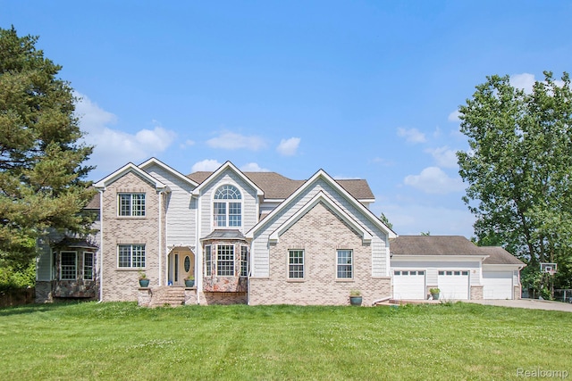 7471 Brewer Rd, Flint, MI 48507 - view of front facade with a front lawn, brick siding, driveway, and a garage