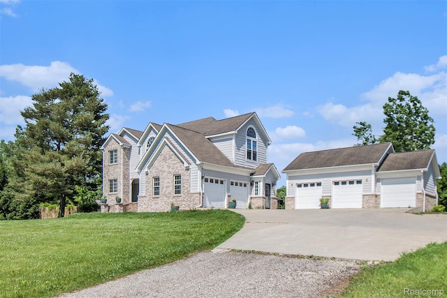 7471 Brewer Rd, Flint, MI 48507 - view of front of home with driveway, a front yard, brick siding, and a garage